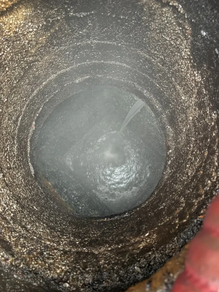 Grease interceptor being rinsed with a water jet after it was pumped out