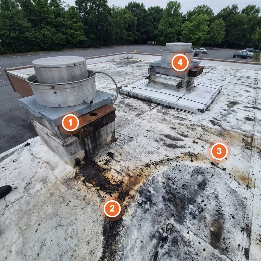 Restaurant roof with grease staining around the exhaust fan curb, with numbered inspection callouts