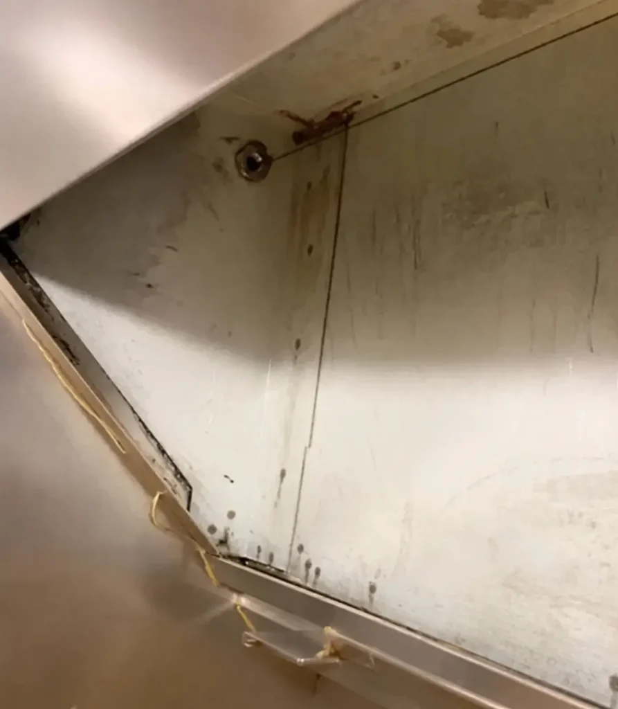 Commercial kitchen hood plenum cleaned to bare metal