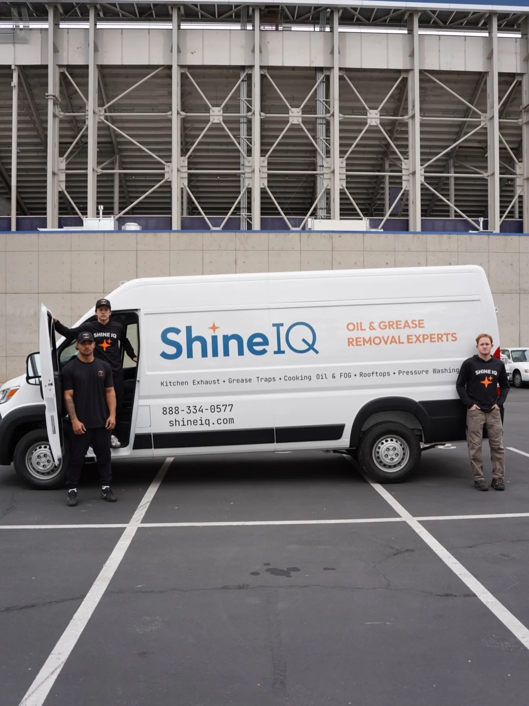 ShineIQ crew standing beside the service van at BYU stadium