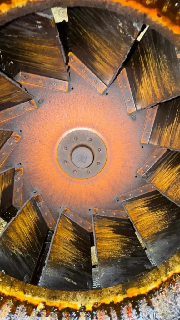 Grease-coated exhaust fan wheel before cleaning