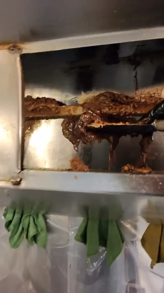 Heavy grease buildup on a kitchen hood ledge