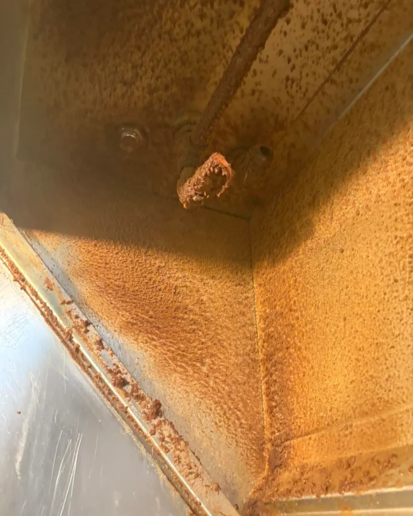 Kitchen hood interior coated in grease before cleaning