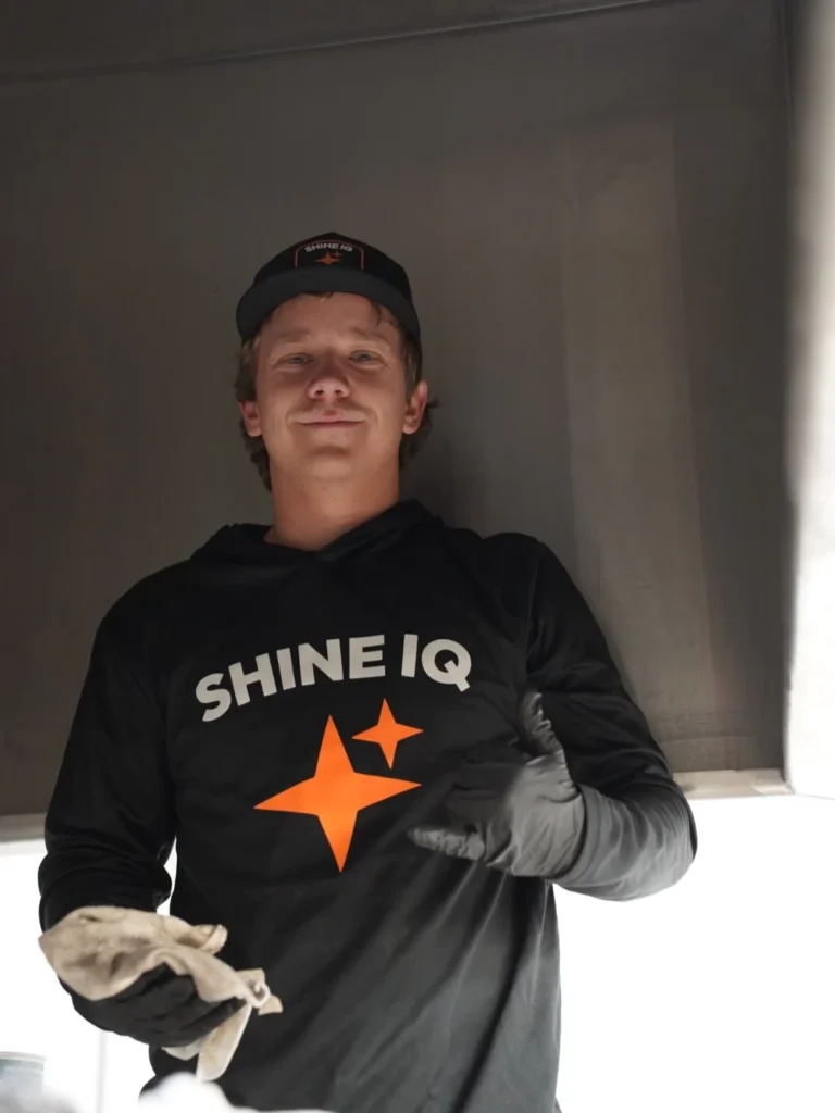 ShineIQ technician giving a thumbs-up beneath a kitchen hood