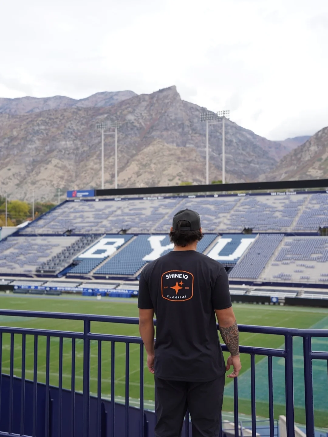 ShineIQ technician overlooking the field and stands at BYU’s LaVell Edwards Stadium